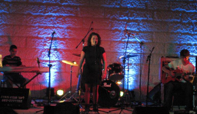 a woman with an electric guitar on stage