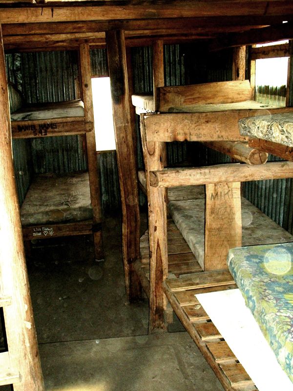 a cabin with bunk beds and mattresses is shown