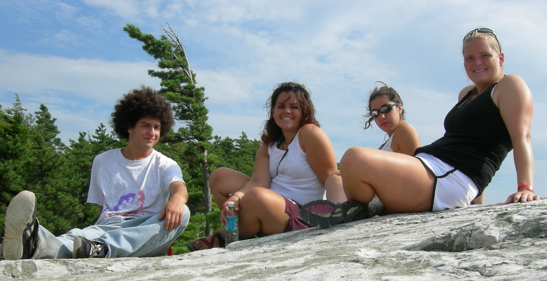 three friends posing on the cliff at the beach