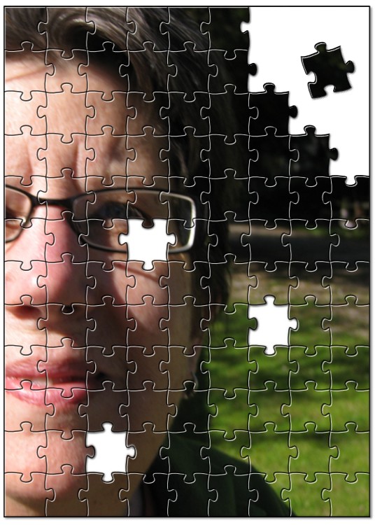 the girl is looking through a large piece of jigsaw puzzle