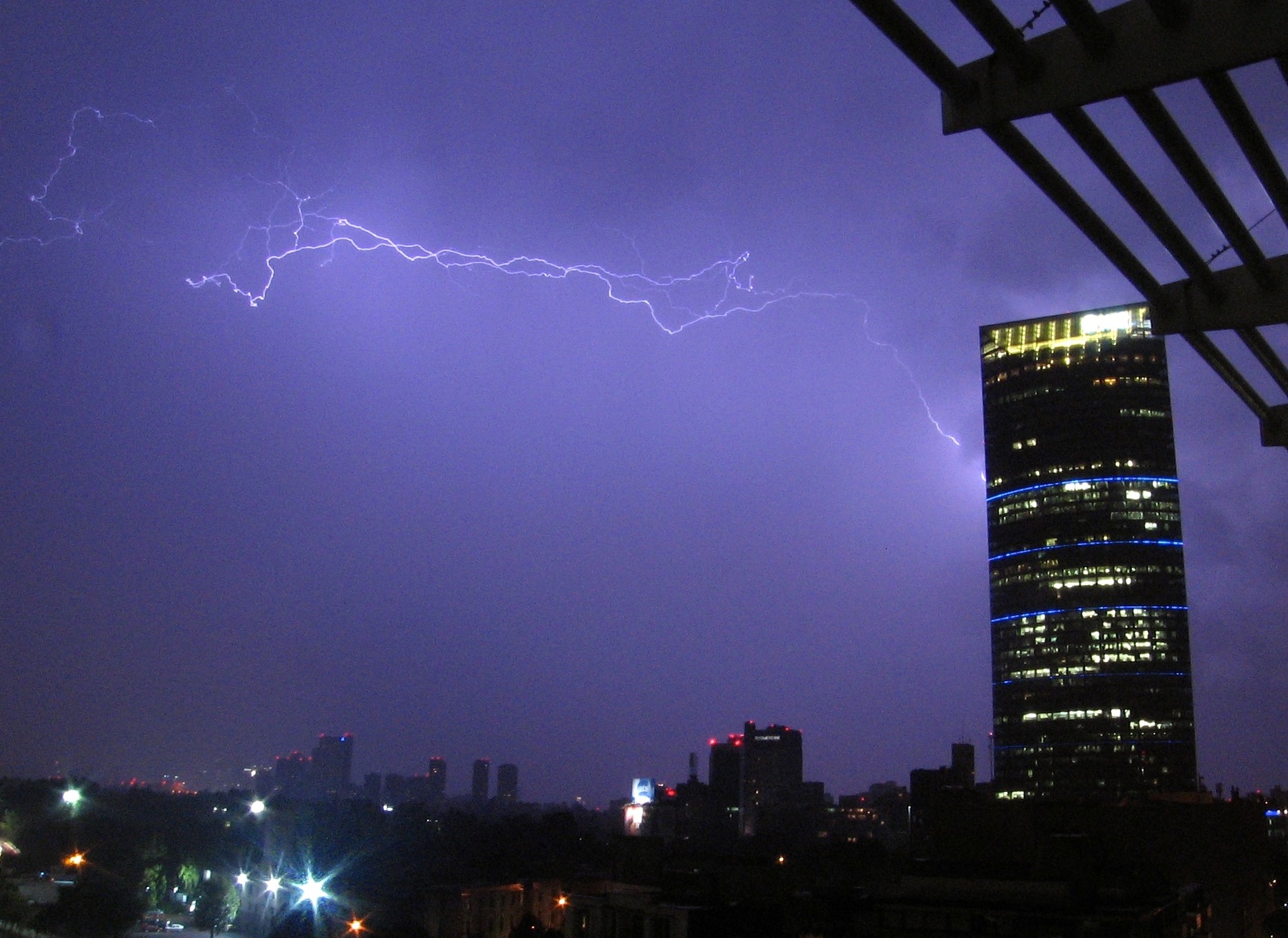 a storm is in the sky and a building is in the distance