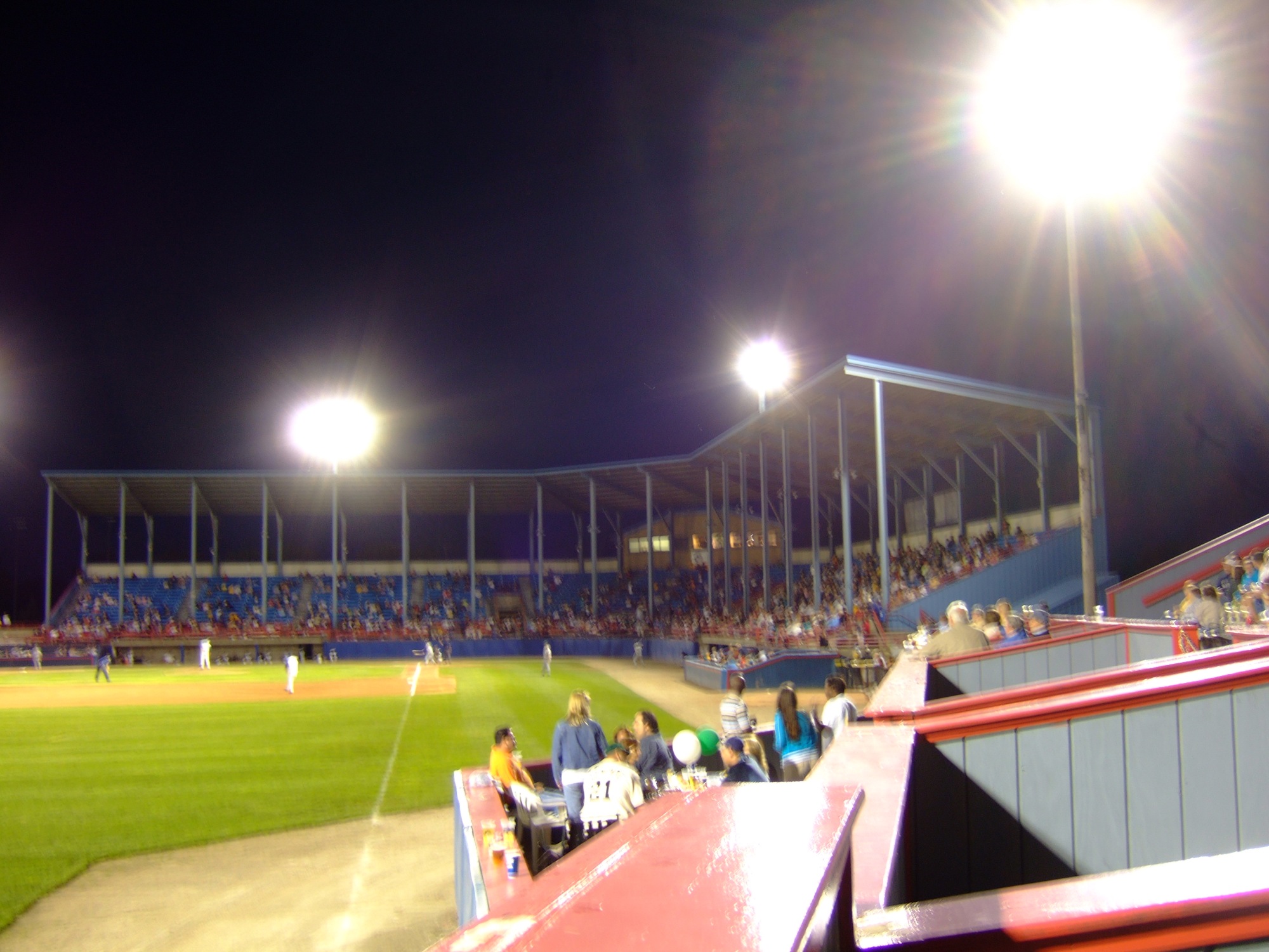 many people are on a stadium watching a baseball game
