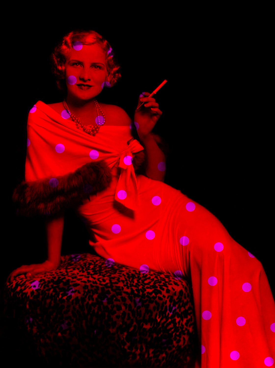 a woman sitting in a chair with polka doted dress and smoking