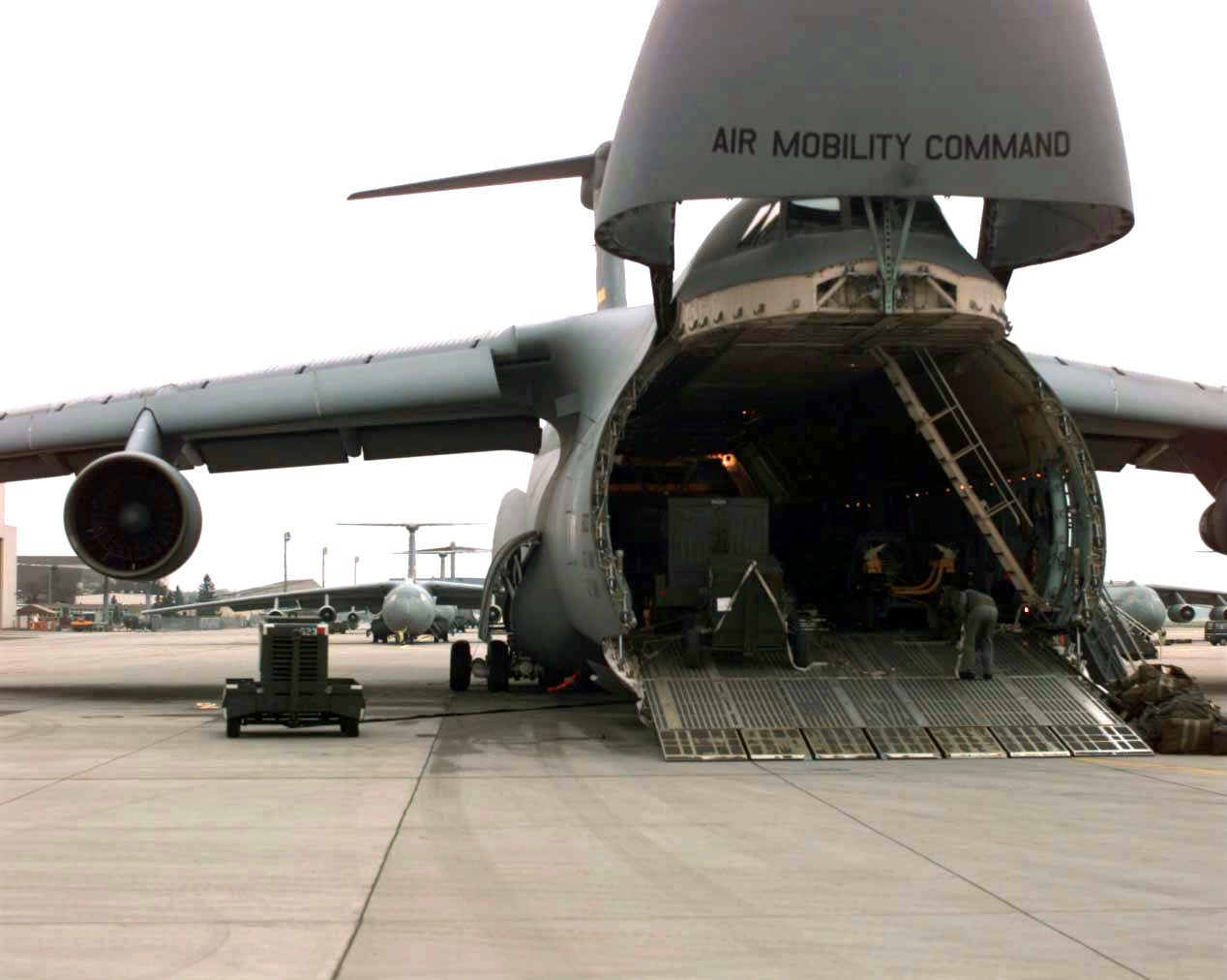 a large airplane with the doors opened on the runway