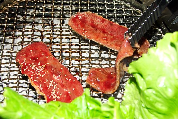 steak pieces sitting on top of some lettuce