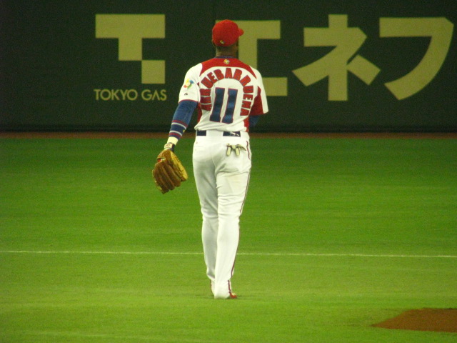 a person wearing a catchers mitt walking onto the field