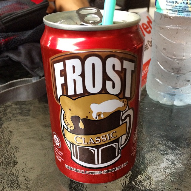 a can of frosty iced soda with a straw in it