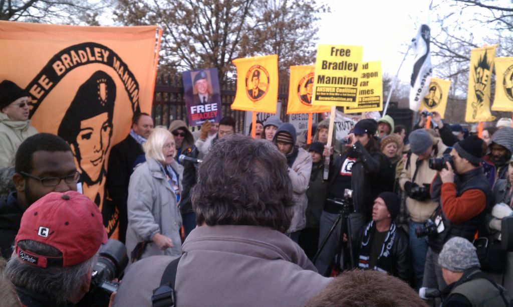 a group of people standing around holding up signs