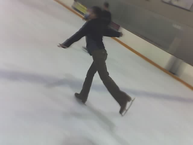 a man that is skateboarding on an ice rink