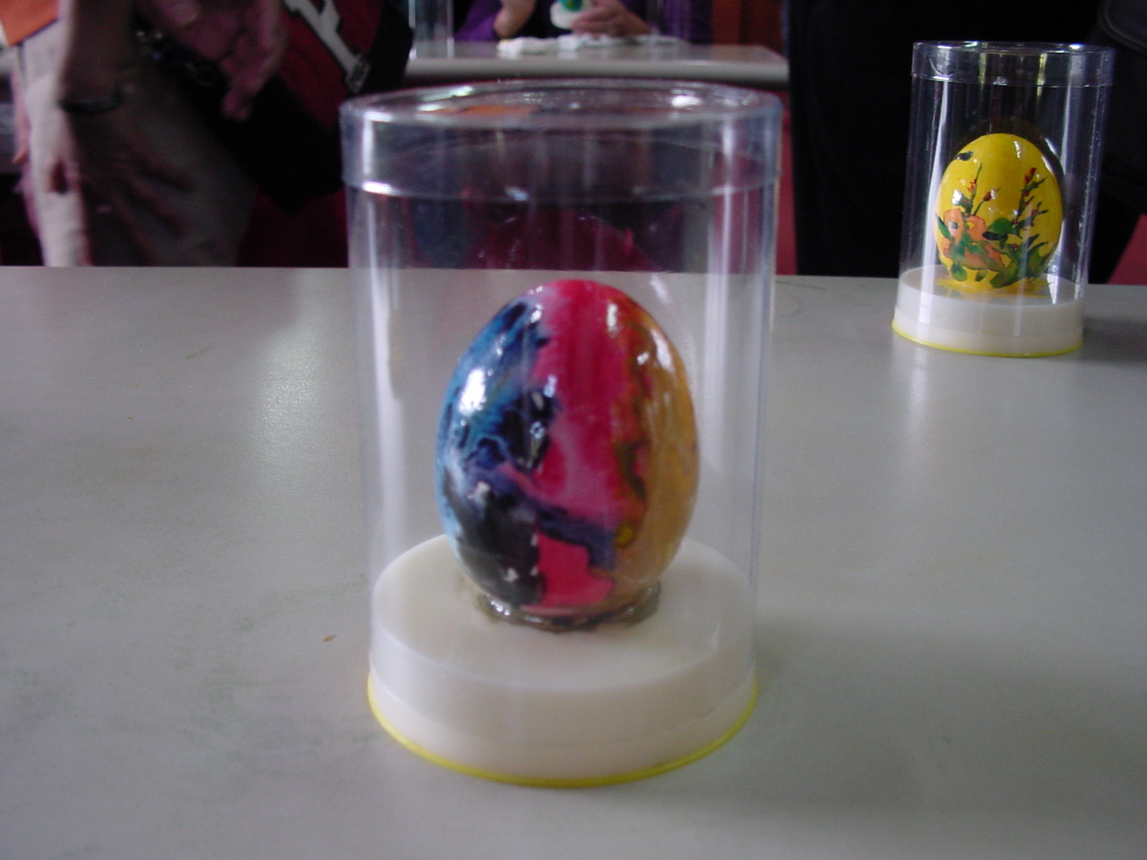 an easter egg sitting inside of a glass case