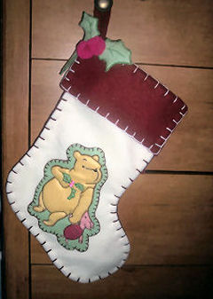 a stocking hanging on the wall with a bear on it