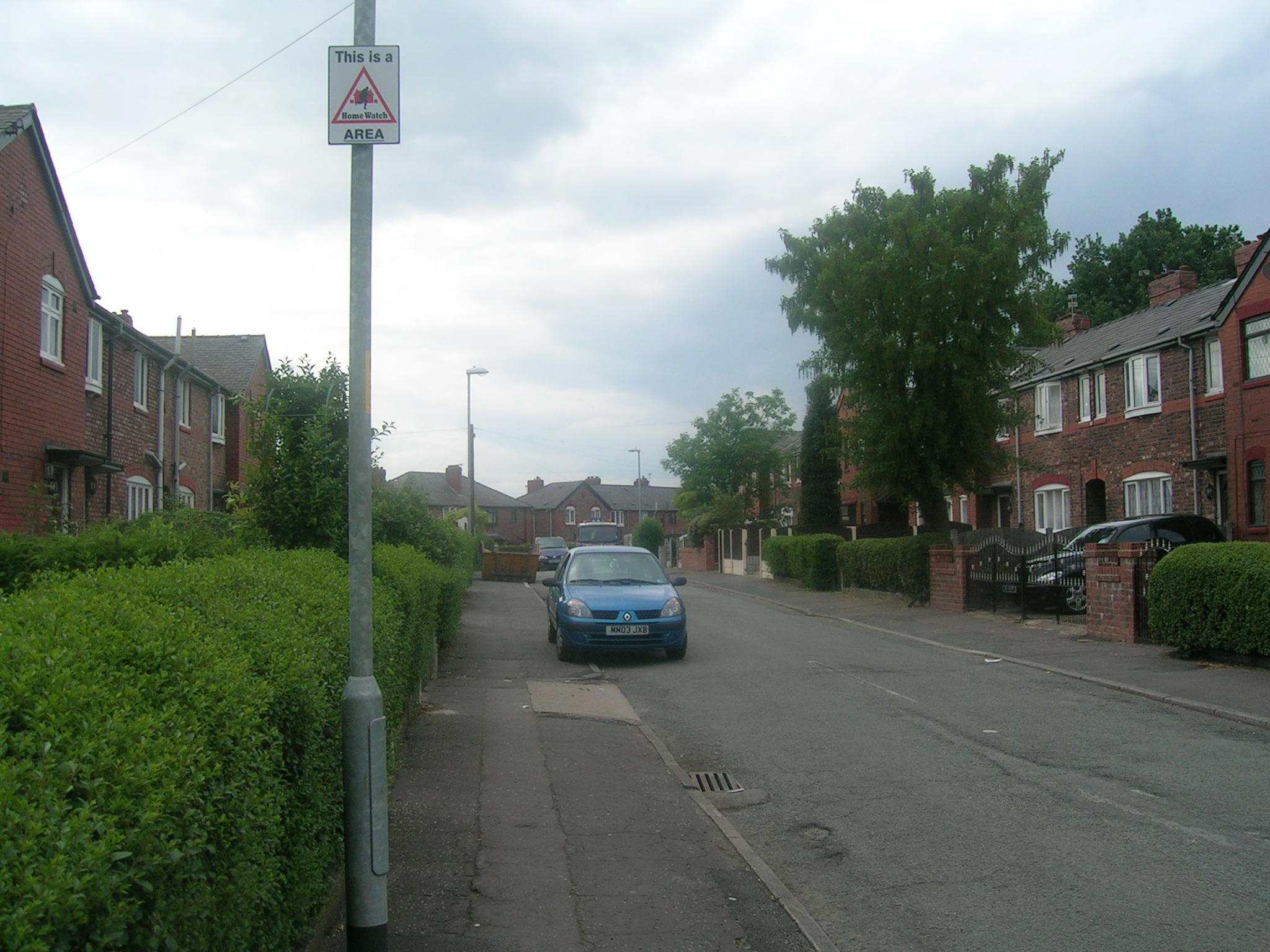 cars parked on the side of a residential street