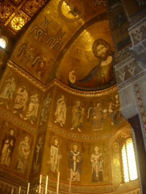 an elaborately decorated wall inside the church with paintings and religious decorations