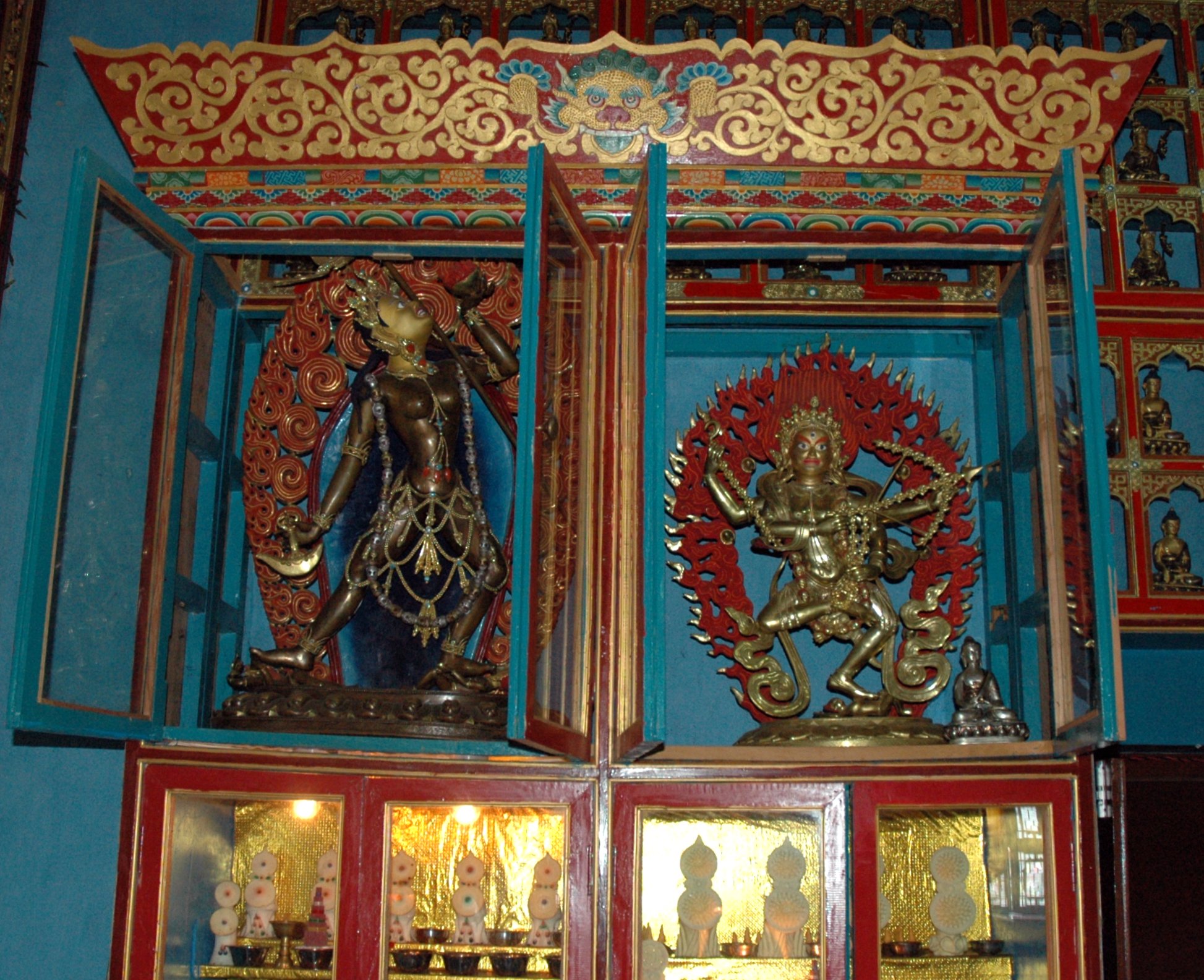 several framed statues displayed in the wall