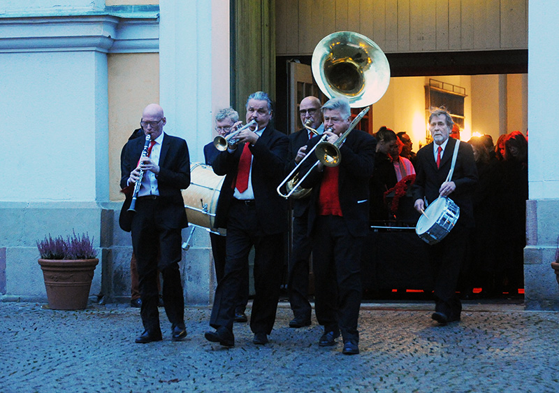 a group of men wearing suits and ties are playing ss instruments