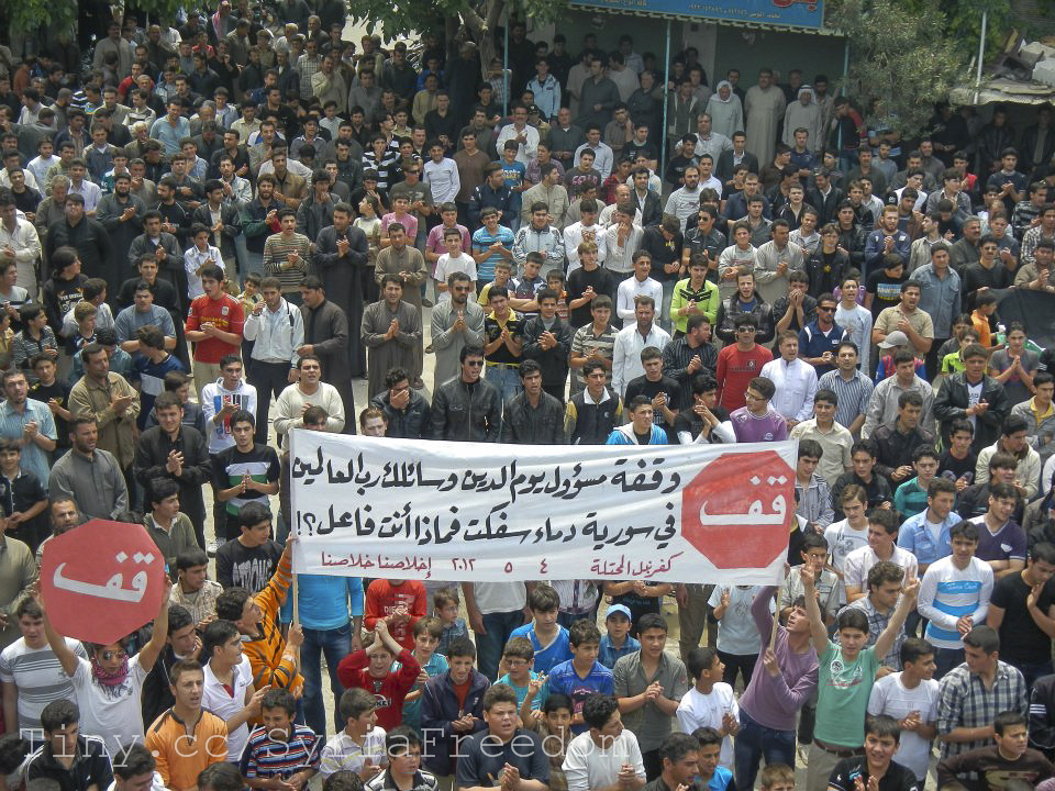 a large crowd holding signs in a protest