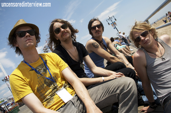 four hipster guys sitting down wearing yellow shirts