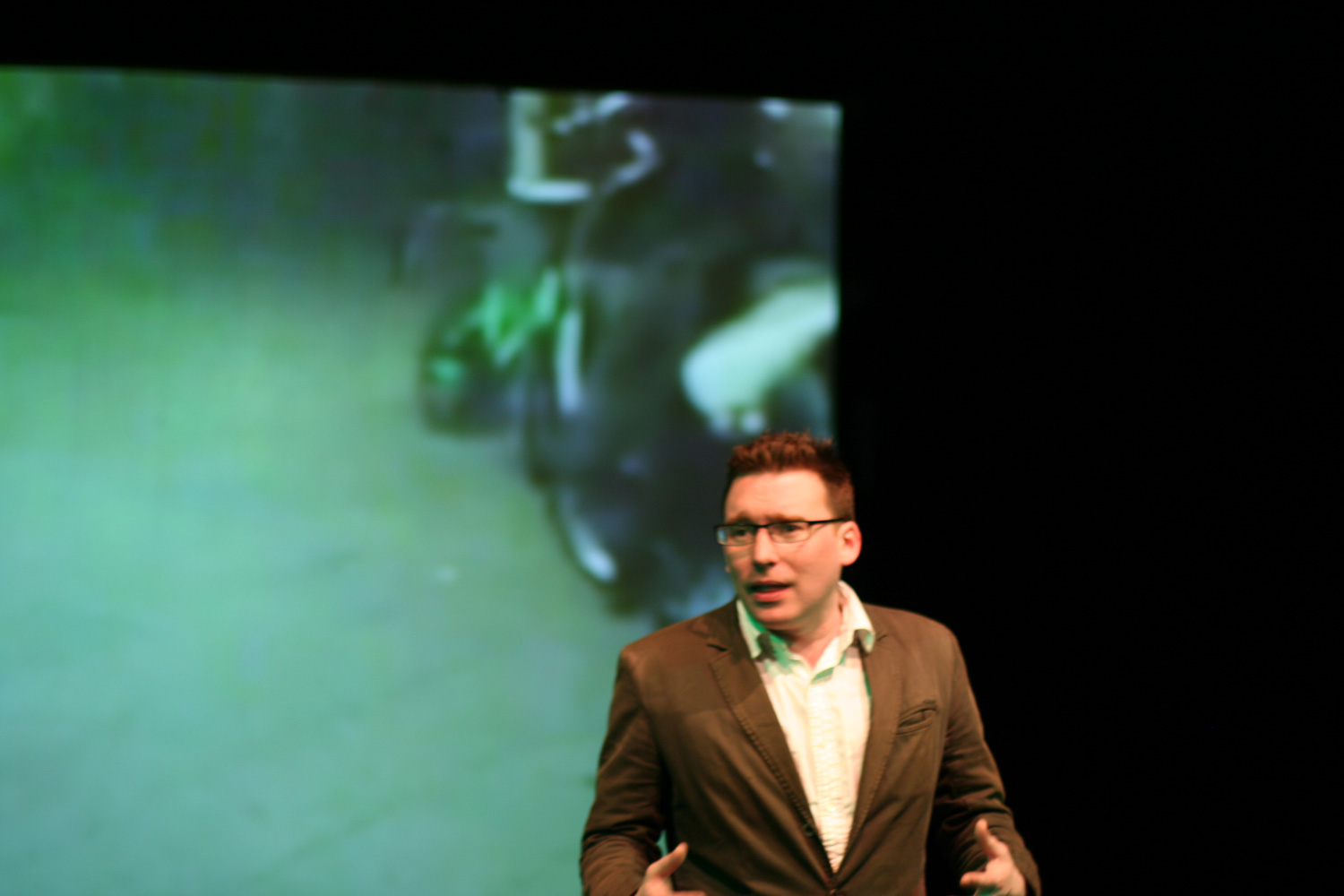 a man standing in front of a projected green image