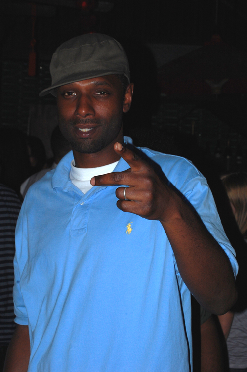 man wearing polo shirt pointing at soing
