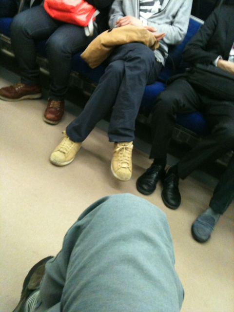 people sitting on a train wearing warm winter clothes