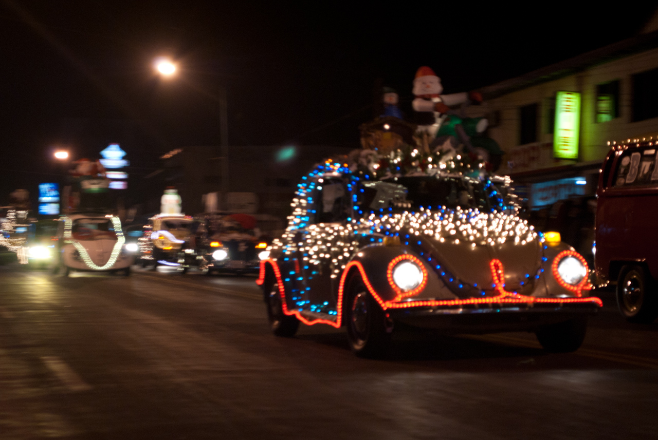 an old car has christmas lights on it