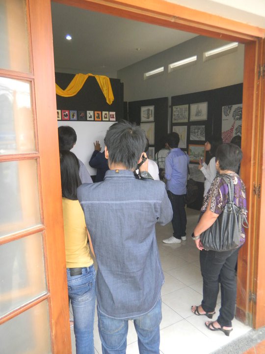 people are gathered around a door to an office