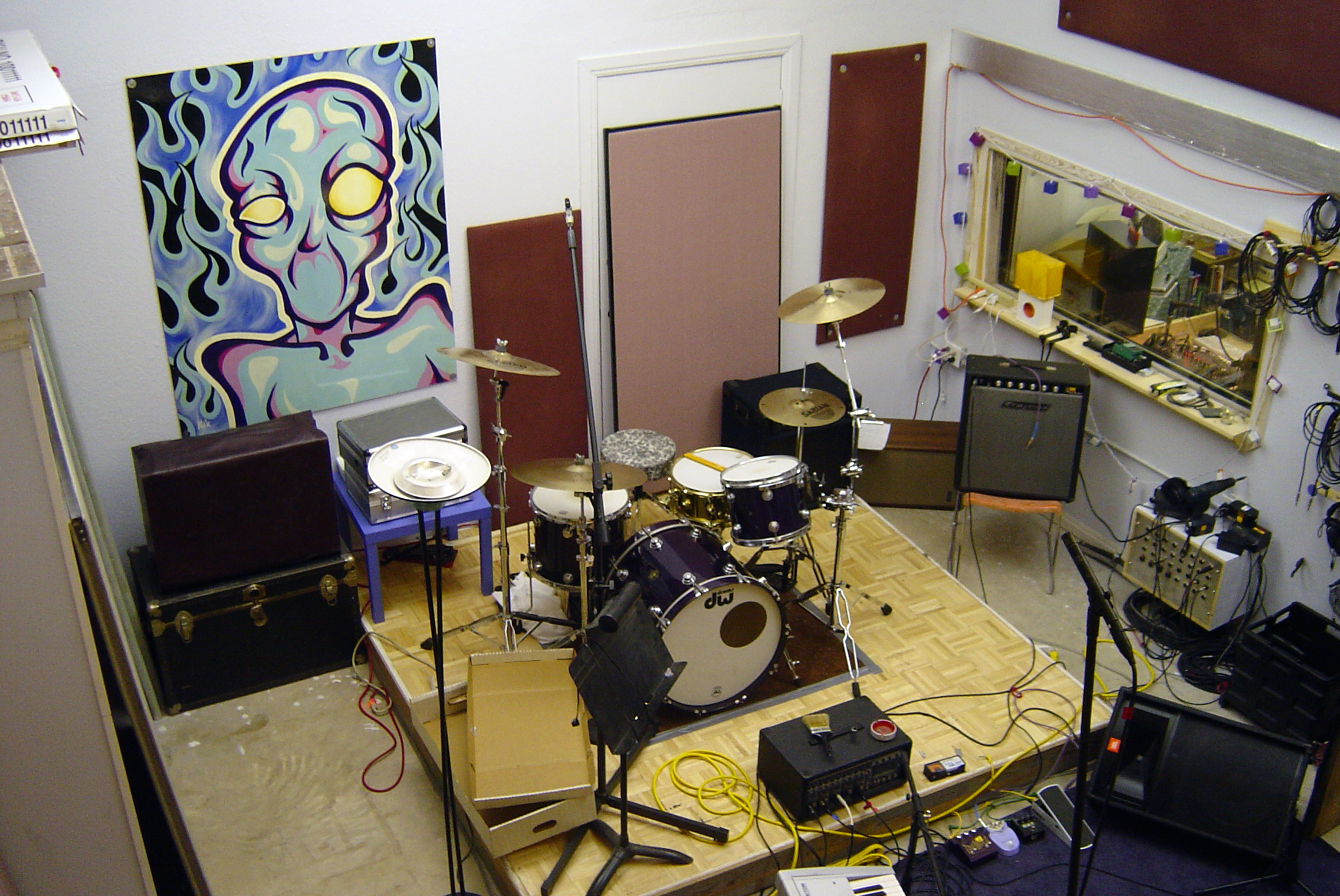 a picture of a living room with musical equipment and recording equipment