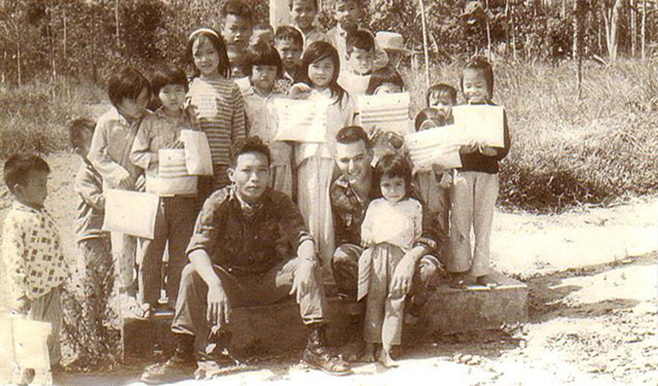 several children are posing in front of a building