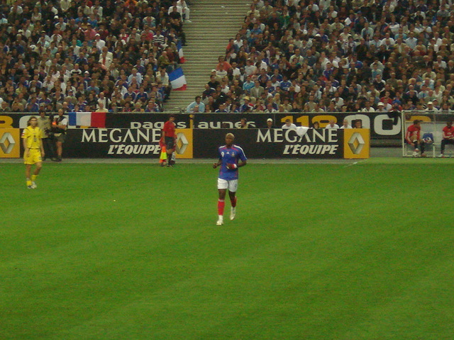 two men standing on a soccer field near each other
