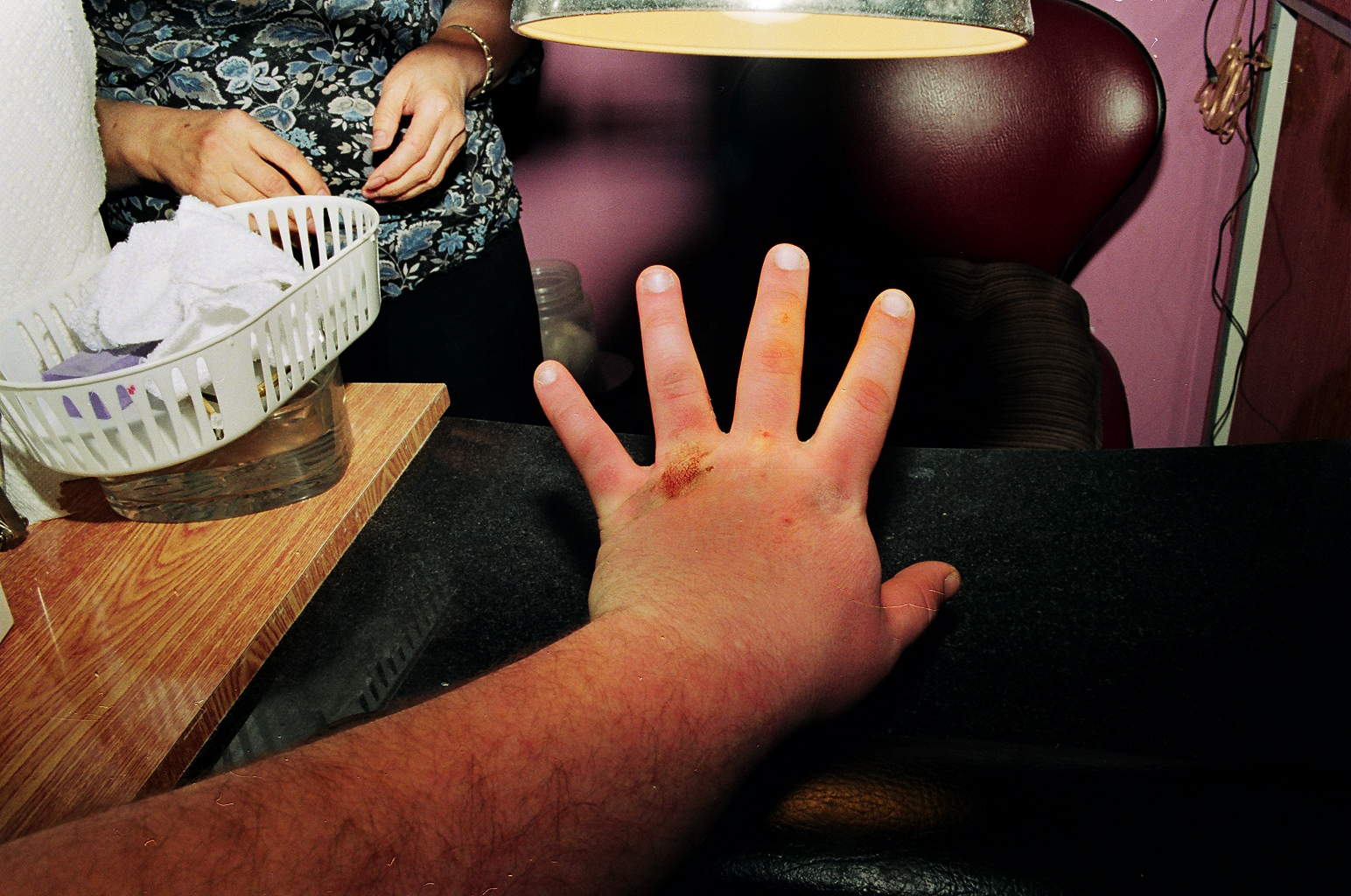 a hand and palm on a wooden table