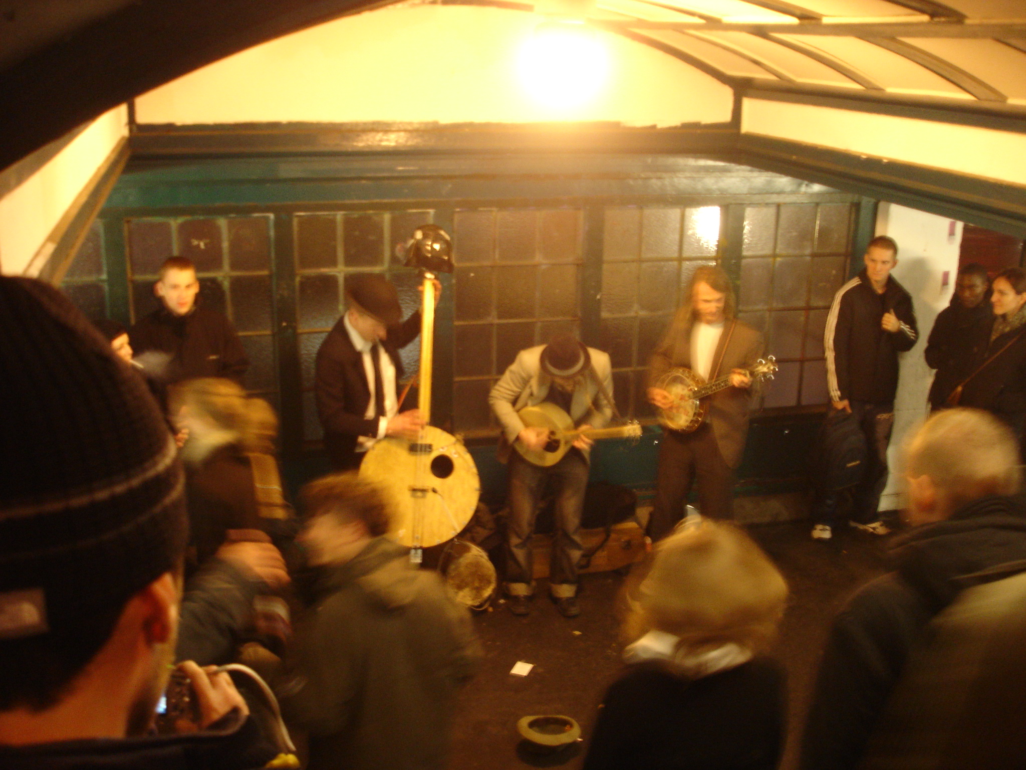 a group of people in an underground bar are playing music