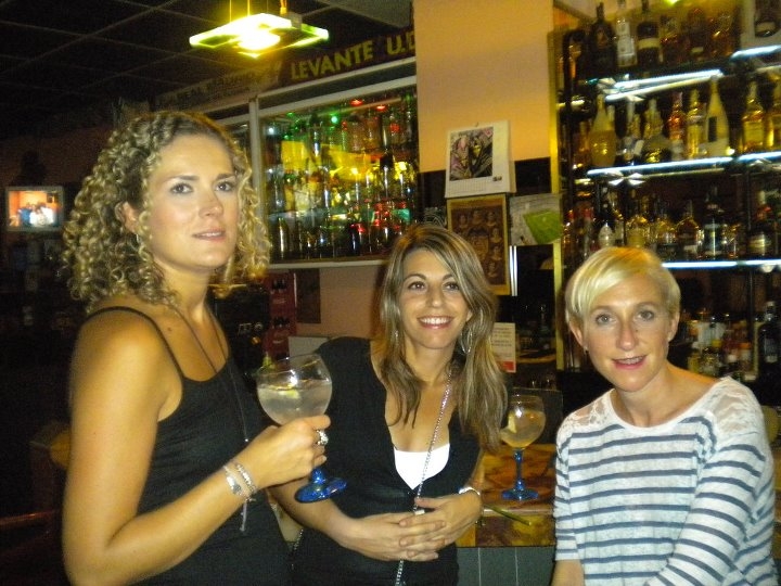 three women are posing for a po with some drinks