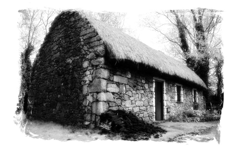 black and white pograph of an old stone house