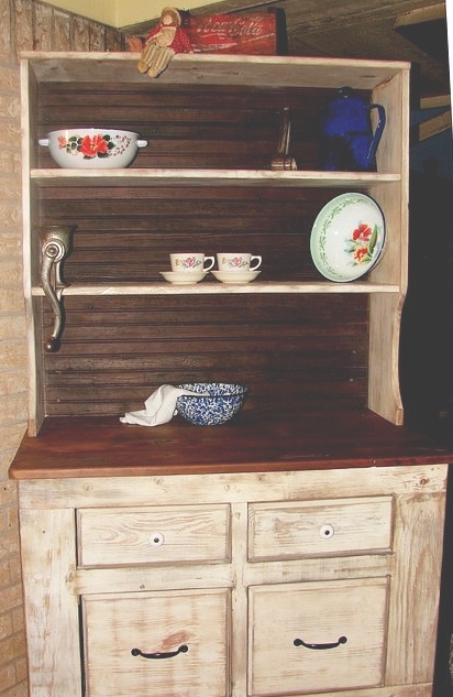 an old wooden china cabinet with bowls and dishes