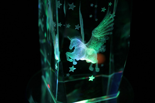 a small glass vase with an illuminated unicorn inside