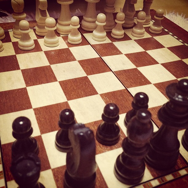 chess pieces are standing on top of a table