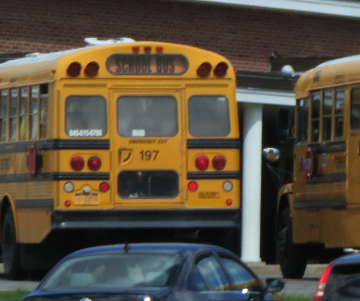 two yellow school buses parked next to each other