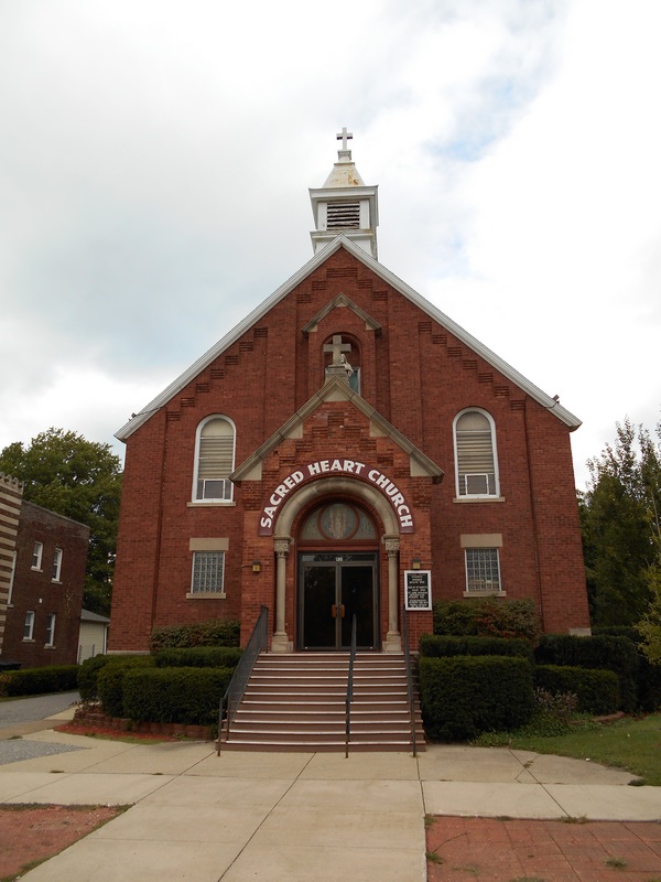 a small church with a steeple and steeple windows