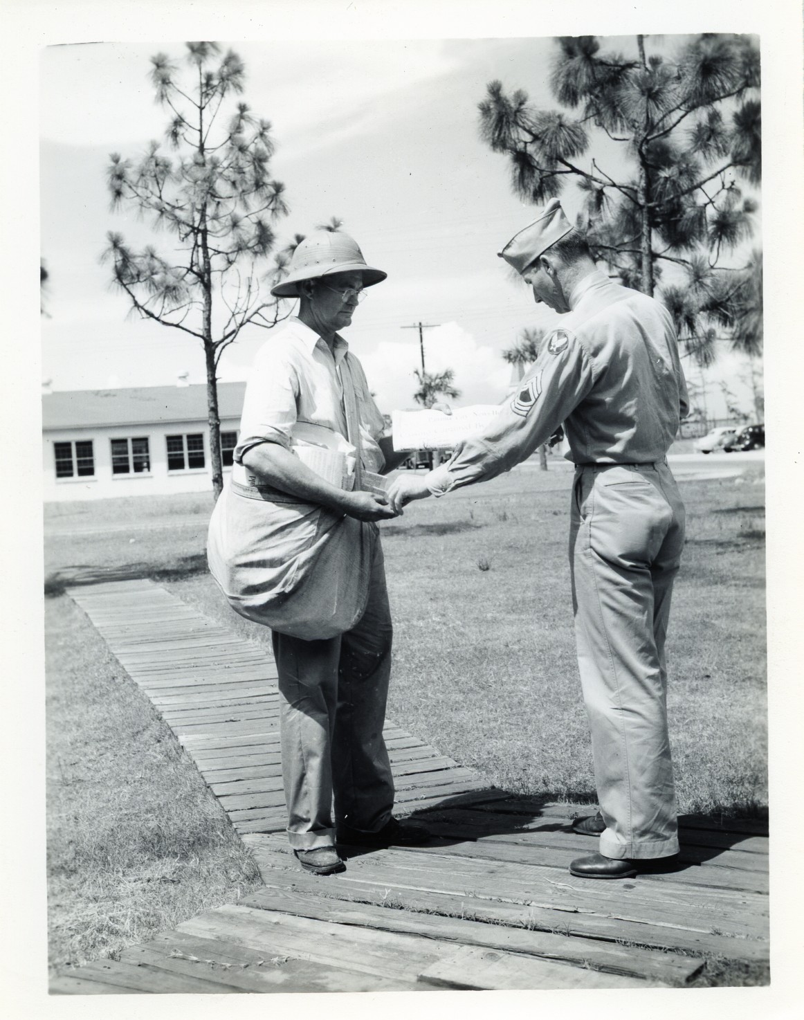 old black and white po of two men in uniform shake hands