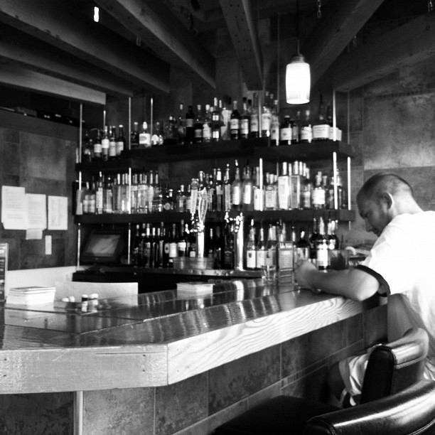 a man sitting at a bar in a restaurant
