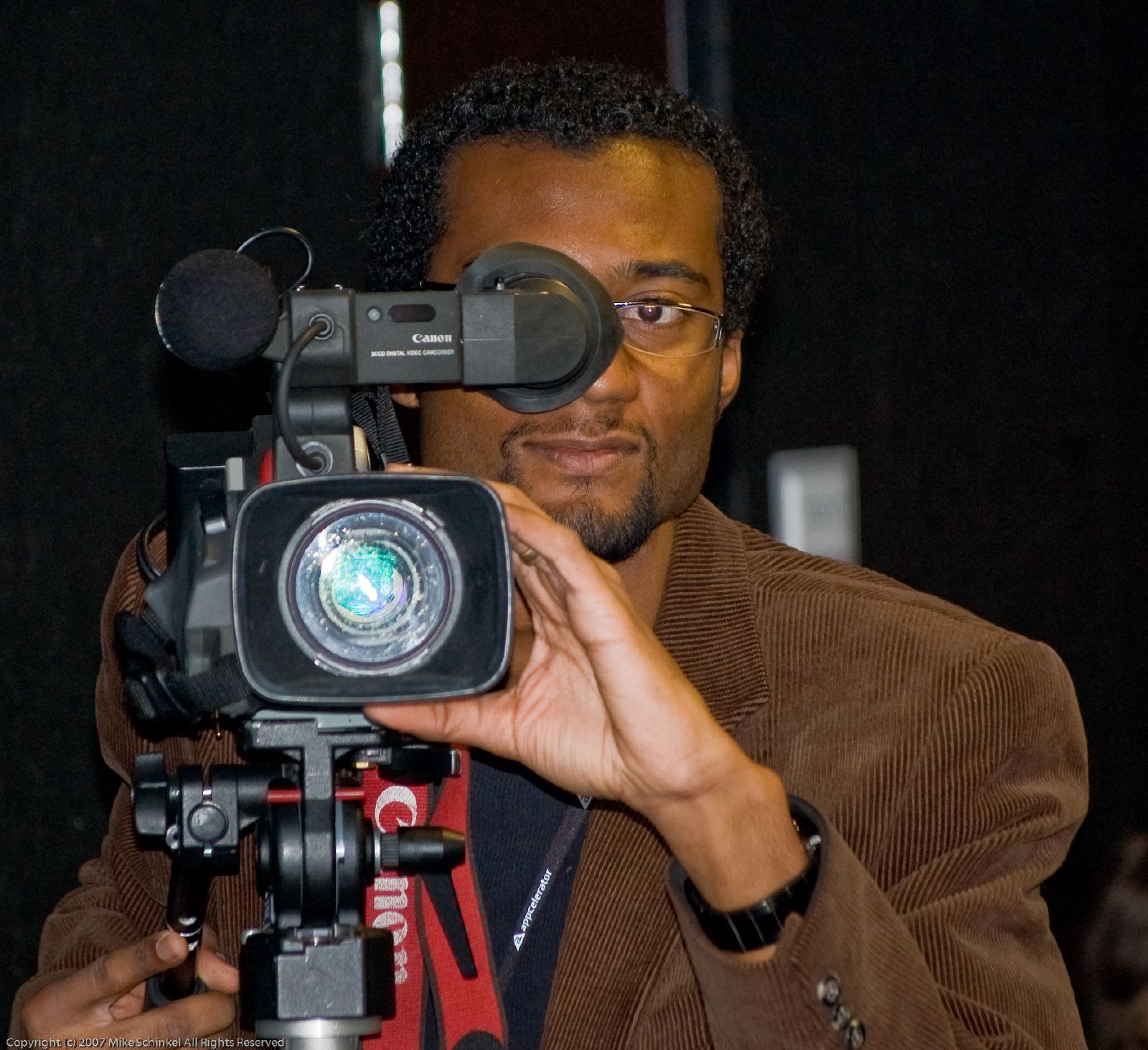 a person in brown coat holding up a camera