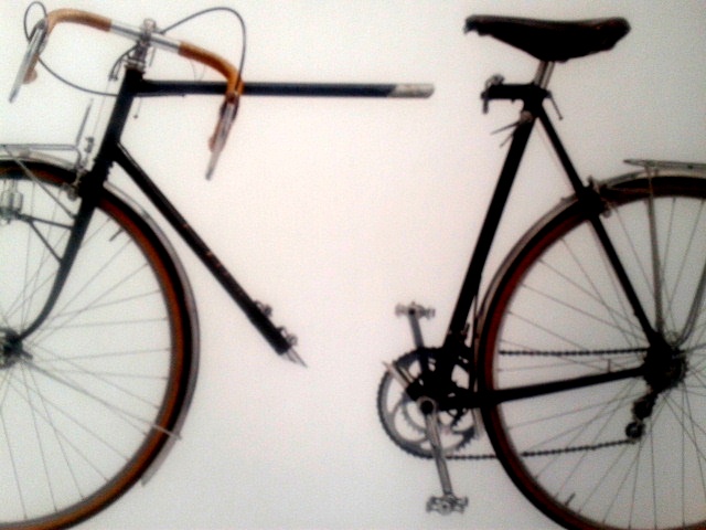 a bicycle mounted on a wall with eye glasses