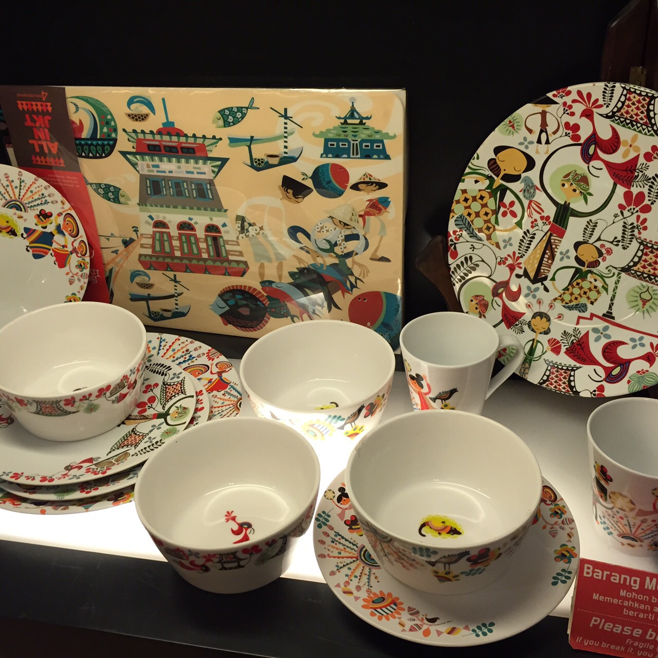 a display of decorative dishes and plates in a display