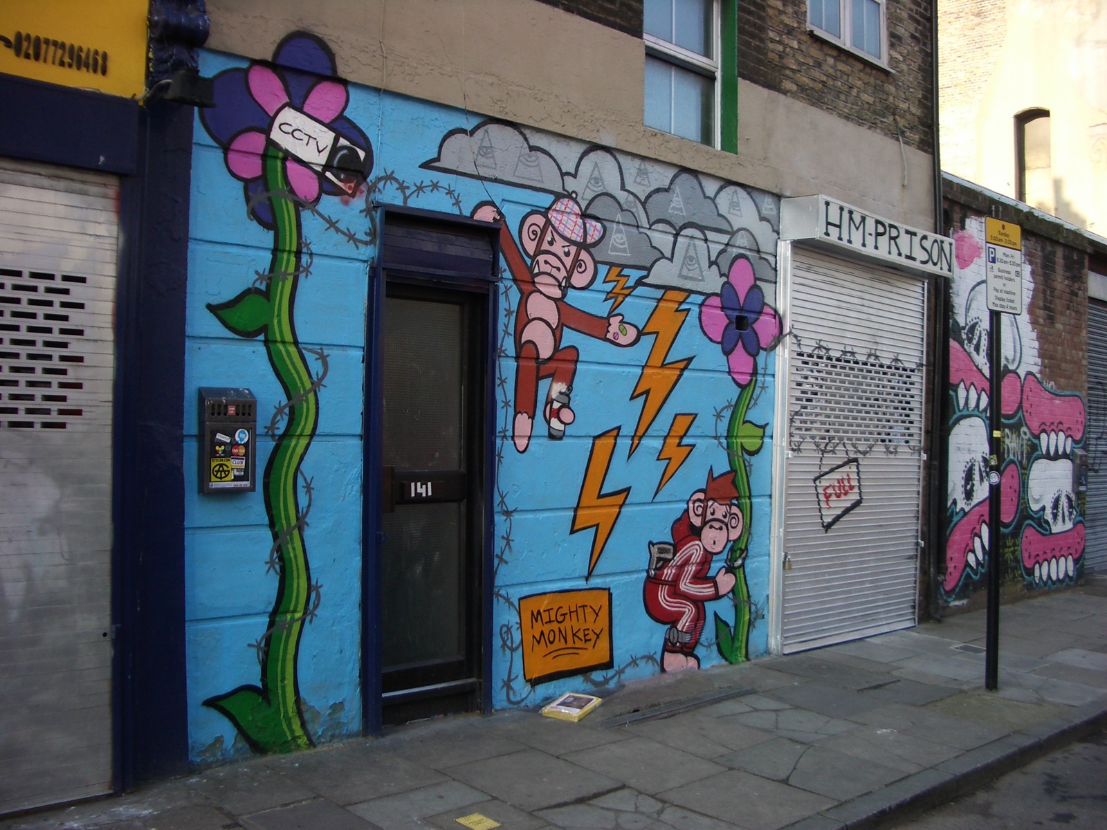a mural on the side of a building of pink and green characters