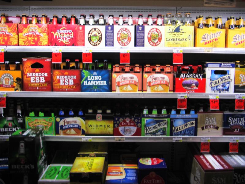 the back wall of a restaurant is filled with lots of beer