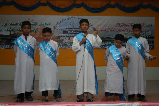 group of boys singing a song at an event