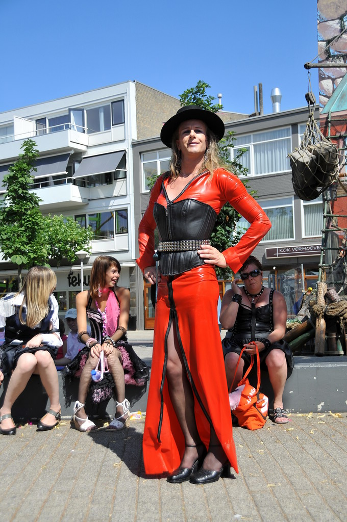 woman standing on a sidewalk in a costume