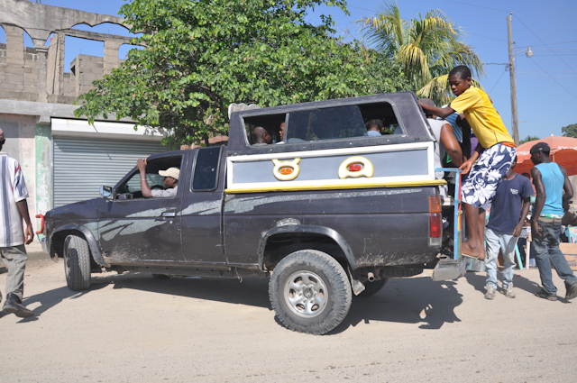 several men who are loading their vehicle onto the side of the road