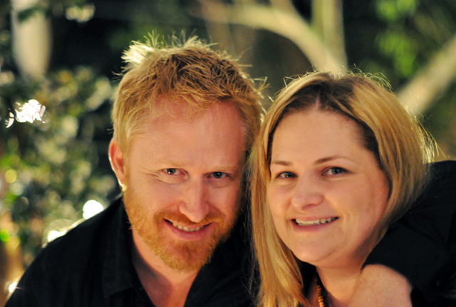 a woman and man smiling for the camera