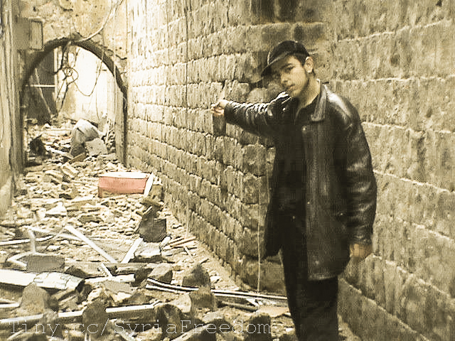 man standing in alley way with debris on the ground